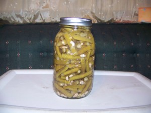 A jar of green beans preserved by canning.