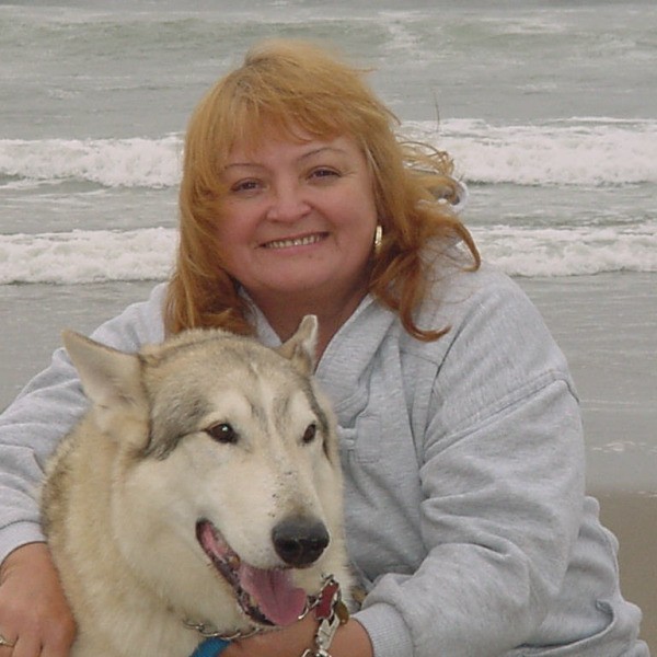 A woman and a dog on the beach in Oregon.