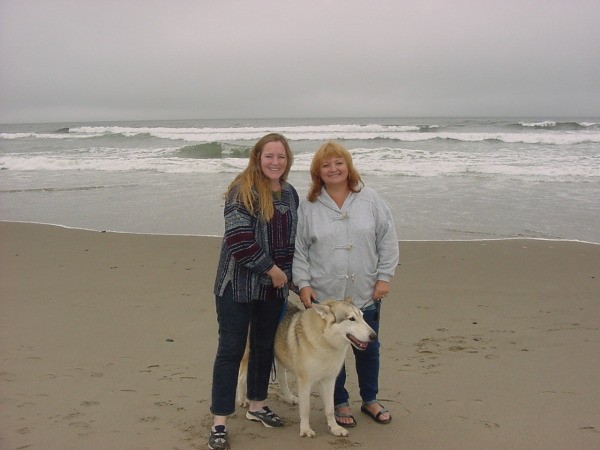 Two women and a dog on the beach in Oregon.