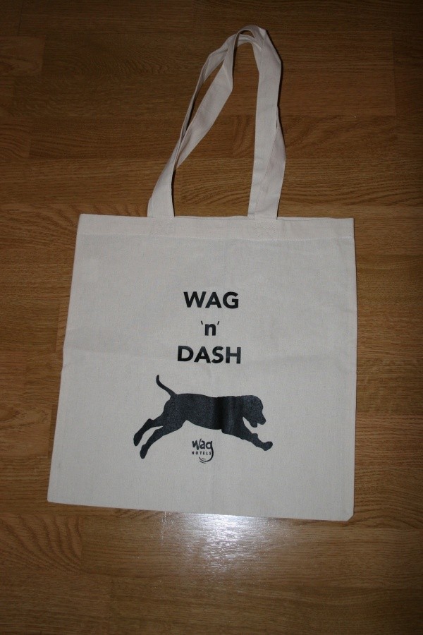 A white canvas bag that says "Wag 'n Dash" in blue