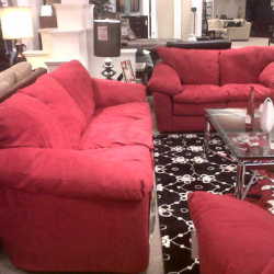 Red couch, loveseat and coffee table arrangement in furniture store