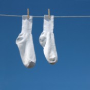 Picture of two socks white socks hanging on a clothesline.