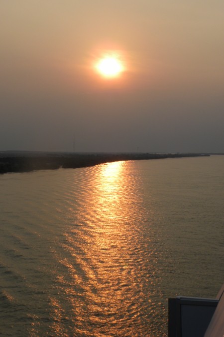 Sunset shining on the rippling waters of the Mississippi River near New Orleans.