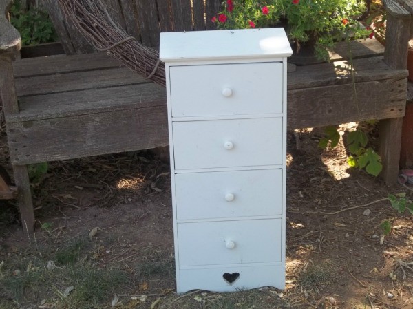 four drawer narrow white chest of drawers with a heart cut out at bottom