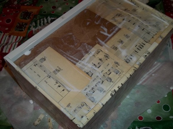 gluing the sheet music onto the bottom of a drawer