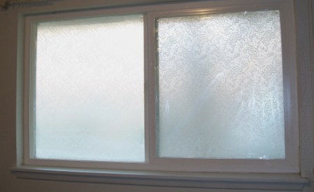 A frosted window with no curtains or blinds.