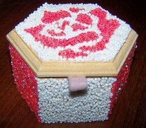 completed pink and white seed bead box with felt loop attached