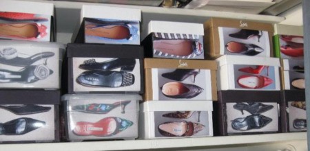 shoe boxes with photos of shoes attached to them