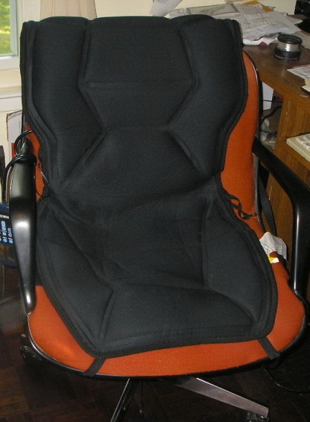 A heating/massage pad on an office chair.