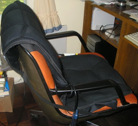 A heating/massage pad on an office chair.