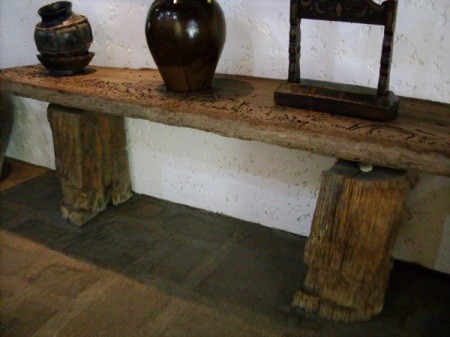 handmade table with base made from two halves of a tree trunk