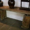 handmade table with base made from two halves of a tree trunk