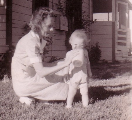 Vintage 1940's picture of mother giving toddler drink of milk