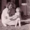 Vintage 1940's picture of mother giving toddler drink of milk