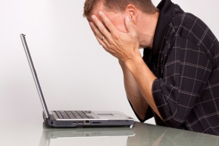 A frustrated man at a laptop
