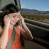 Keeping Kids Entertained on Road Trips, Photo of a child with earphones on in the back seat of a car.