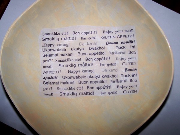 Bowl with first piece "word" paper set in center of bowl interior.