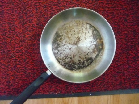 photo of interior of burned stainless steel frying pan