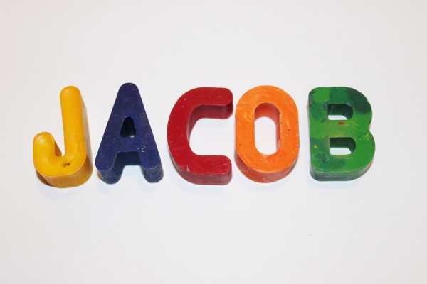 "Jacob"spelled with alphabet crayons