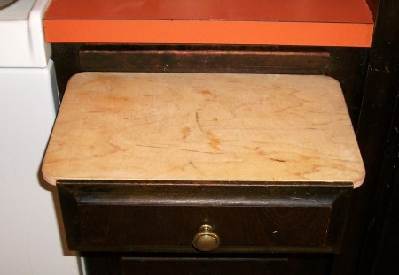 Place a cutting board on top of a seldom used drawer.