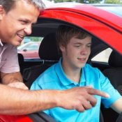 Father teaching his son to drive