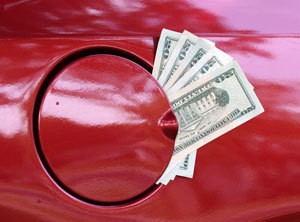 Saving Money on Gas, picture of money coming out of a cars gas tank