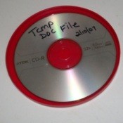 An oatmeal lid used to hold a burned CD.