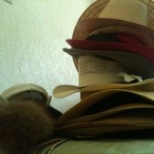 A stack of hats that need to be organized.
