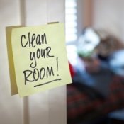 Post it note that says clean your room on it.