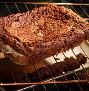 Brownies overflowing on oven rack and bottom