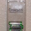 Plastic adhesive nail packing with batteries inside and "charged" written on the outside