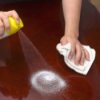 Hands polishing a wood table
