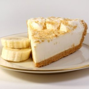 A slice of banana cream pie on a plate with slices of fresh banana.