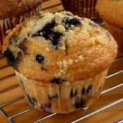 Blueberry muffin on a cooling rack.