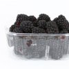Clear container with blackberries inside.