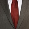 A business suit with a white shirt and red tie.