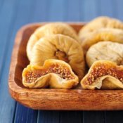 Dried figs in a wooden bowl.