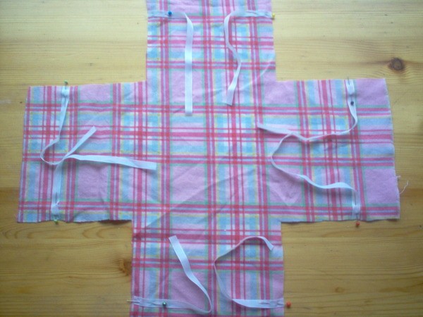 Ribbons pinned to plaid fabric