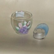 Glass Votive Holder next to a votive candle that melted into an odd shape