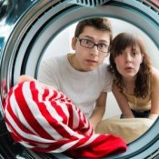 Picture of a red striped shirt in a washer.