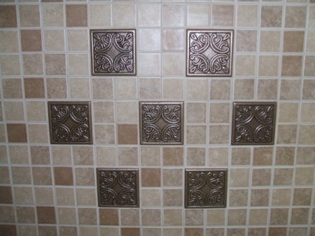 Completed tile back splash made up of small tiles and 7 large tiles