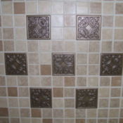 Completed tile back splash made up of small tiles and 7 large tiles