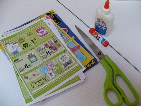 sheets of paper, scissors, glue and glue stick on a table