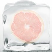 Slice of grapefruit in an ice cube.