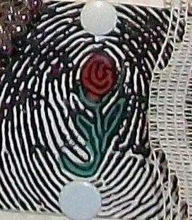 A close up of a fingerprint with a rose in the middle.