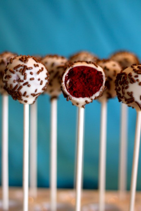 Valentine's Cake Pops, A row of cake pops with Red Velvet centers.