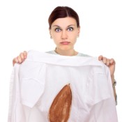 Woman Holding Up Shirt With Iron Burn