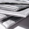 Stack of Newspaper on White Background