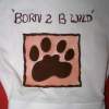 A baby's onsie with a fabric paint design of a paw and the words "Born 2 B Wild".