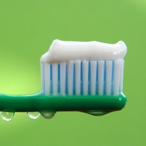 Closeup of wet toothbrush with paste.